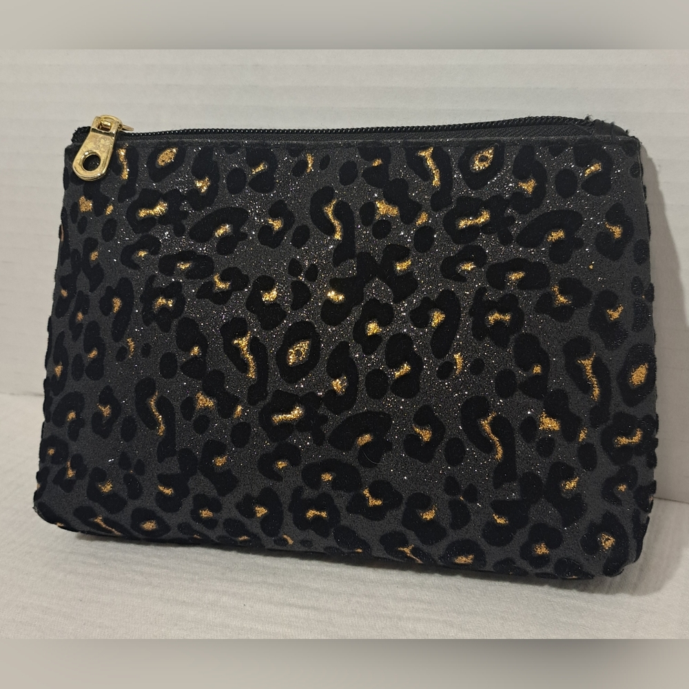 Black cosmetic bag with cheetah and zipper design.